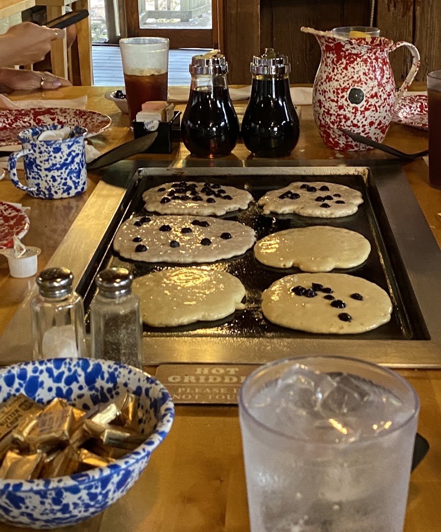 Family dining with pancake batter at the table.